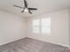 A bedroom with a ceiling fan, carpeted floor, and natural light from two windows at 9127 Colwick Hill Ln, Charlotte, NC 28215