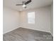 Bedroom with stylish hard surface floors, a ceiling fan, and a window for natural light at 9127 Colwick Hill Ln, Charlotte, NC 28215