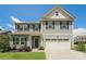 Charming two-story home with blue siding, a two-car garage and well-maintained landscaping at 9127 Colwick Hill Ln, Charlotte, NC 28215