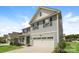 Side view of a charming two-story home with blue siding and a two-car garage at 9127 Colwick Hill Ln, Charlotte, NC 28215