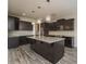 Modern kitchen featuring dark wood cabinets, granite countertops, and stainless steel appliances at 9127 Colwick Hill Ln, Charlotte, NC 28215