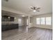Open-concept living area with gray wood floors seamlessly connecting to a modern kitchen at 9127 Colwick Hill Ln, Charlotte, NC 28215