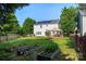Large backyard featuring raised garden beds, a gazebo, and a solar paneled home at 9414 Seamill Rd, Charlotte, NC 28278