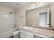 Bathroom with large mirror, countertop, sink, toilet, and tub/shower at 9414 Seamill Rd, Charlotte, NC 28278