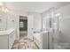 Bathroom featuring double sinks, a soaking tub, and a tiled floor at 9414 Seamill Rd, Charlotte, NC 28278