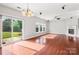 Relaxing living room features hardwood floors, backyard access, and a classic fireplace at 9414 Seamill Rd, Charlotte, NC 28278