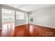 Spacious living room showcasing hardwood floors, neutral paint, and natural lighting at 9414 Seamill Rd, Charlotte, NC 28278