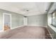 Spacious main bedroom with en suite bathroom and tray ceiling with ceiling fan at 9414 Seamill Rd, Charlotte, NC 28278
