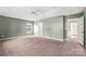 Spacious main bedroom with en suite bathroom and neutral walls and carpet at 9414 Seamill Rd, Charlotte, NC 28278