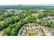 Aerial view featuring a neighborhood near the city, surrounded by lush trees and landscaping at 1006 Phil Oneil Dr, Charlotte, NC 28215