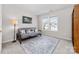 Well-lit bedroom with a large window, a futon, and a patterned rug at 1006 Phil Oneil Dr, Charlotte, NC 28215