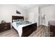 Bedroom showcasing wood-look floors and an en suite bathroom at 1006 Phil Oneil Dr, Charlotte, NC 28215
