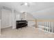 Bonus room with a piano and a railing overlooking the lower level at 1006 Phil Oneil Dr, Charlotte, NC 28215