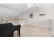 Bonus room with neutral carpet and a piano near the railing at 1006 Phil Oneil Dr, Charlotte, NC 28215