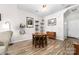 Cozy dining area with round wood table, adjacent to the living room and entrance at 1006 Phil Oneil Dr, Charlotte, NC 28215