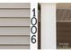 Close up of the house number '1006' attached to the exterior of the home at 1006 Phil Oneil Dr, Charlotte, NC 28215