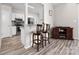 Kitchen view that includes a bar counter, appliances, and hardwood floors at 1006 Phil Oneil Dr, Charlotte, NC 28215