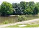 Scenic view of the pond, benches, and lush greenery, offering a tranquil outdoor space at 1006 Phil Oneil Dr, Charlotte, NC 28215
