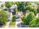 Aerial view of charming home with lush greenery, driveway, and surrounding neighborhood at 10330 Seedling Ln, Charlotte, NC 28214