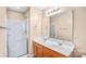 Bathroom featuring a double sink vanity and a walk-in shower at 10330 Seedling Ln, Charlotte, NC 28214