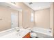 Bathroom with large mirror, bathtub, and updated vanity at 10330 Seedling Ln, Charlotte, NC 28214