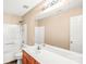 A bathroom featuring neutral walls, a vanity, a mirror, and a shower-tub combo at 10330 Seedling Ln, Charlotte, NC 28214