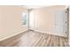 Bright bedroom featuring a window and two doors at 10330 Seedling Ln, Charlotte, NC 28214