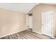 A simple bedroom featuring neutral walls, wood-look flooring, and a white door at 10330 Seedling Ln, Charlotte, NC 28214