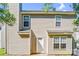 A two-story home with tan siding, a front door, multiple windows, and a blue sky at 10330 Seedling Ln, Charlotte, NC 28214