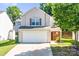 Charming two-story home with a large two-car garage and a well-maintained front yard at 10330 Seedling Ln, Charlotte, NC 28214