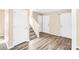 Hallway with wood-look flooring, white walls, and a staircase leading to the upper level at 10330 Seedling Ln, Charlotte, NC 28214