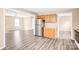 Open kitchen featuring stainless steel appliances, wood cabinets, and new floors at 10330 Seedling Ln, Charlotte, NC 28214