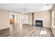Open living space featuring new floors connecting the living room to the kitchen and front door at 10330 Seedling Ln, Charlotte, NC 28214