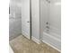Clean bathroom featuring a white tiled shower-tub and neutral vinyl flooring at 1043 Park West Dr, Charlotte, NC 28209