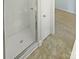 Modern tiled bathroom features a glass-enclosed shower, enhancing cleanliness and style at 1043 Park West Dr, Charlotte, NC 28209