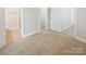 Spacious carpeted bedroom features a ensuite bathroom, closet and neutral paint, providing a calming and inviting atmosphere at 1043 Park West Dr, Charlotte, NC 28209