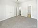 Spacious bedroom features neutral carpet, a large closet, and an open doorway to the hallway at 1043 Park West Dr, Charlotte, NC 28209
