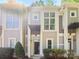 Attractive townhome exterior with a well-kept lawn and inviting front entrance at 1043 Park West Dr, Charlotte, NC 28209