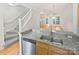 Stylish kitchen features stainless steel appliances, granite countertops and breakfast bar overlooking the living area at 1043 Park West Dr, Charlotte, NC 28209