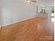 Open-concept living area featuring hardwood floors and a view of the kitchen and backyard at 1043 Park West Dr, Charlotte, NC 28209