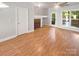 Bright living room with hardwood floors, a cozy fireplace, and a sliding glass door to the backyard at 1043 Park West Dr, Charlotte, NC 28209