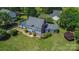 Aerial view of the blue two-story home with a vast front lawn and green landscaping at 106 Chatworth Ln, Mooresville, NC 28117