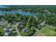 Aerial view of the blue house with extensive yard and landscaping near the lake at 106 Chatworth Ln, Mooresville, NC 28117