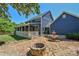 A backyard featuring a fountain, a stone fire pit, and a covered porch at 106 Chatworth Ln, Mooresville, NC 28117