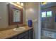This is a bathroom with a granite-topped vanity, framed mirror, and a tub/shower combination at 106 Chatworth Ln, Mooresville, NC 28117