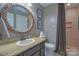 Bathroom with a vanity, framed mirror, and a shower with a dark shower curtain at 106 Chatworth Ln, Mooresville, NC 28117