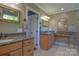Bathroom with granite counters, framed mirrors, and neutral color scheme at 106 Chatworth Ln, Mooresville, NC 28117