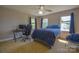 Bedroom with desk, blue walls, carpet, and natural light from the window at 106 Chatworth Ln, Mooresville, NC 28117