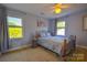 Bedroom features carpet, light blue walls, and two windows at 106 Chatworth Ln, Mooresville, NC 28117