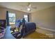 This bedroom offers a comfortable carpet, a lighted ceiling fan and two windows for ample natural light at 106 Chatworth Ln, Mooresville, NC 28117